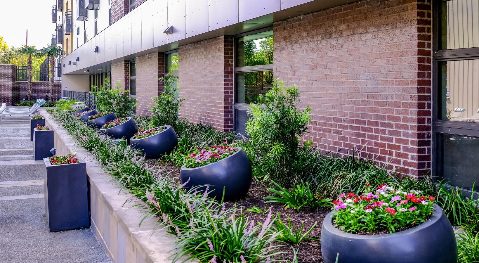 Settle into comfort at Berkshire Riverview a patio with chairs and plants