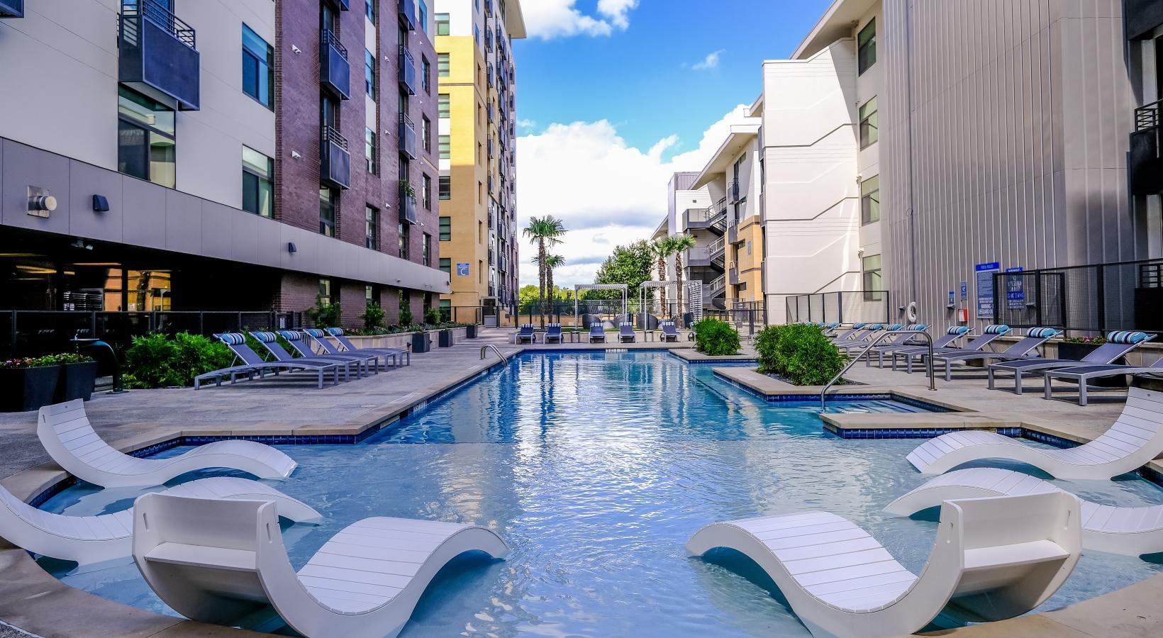 The essence of exceptional living a pool with lounge chairs around it