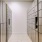 a hallway with white tile walls