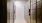 a hallway with white tile walls