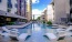 a pool with lounge chairs around it