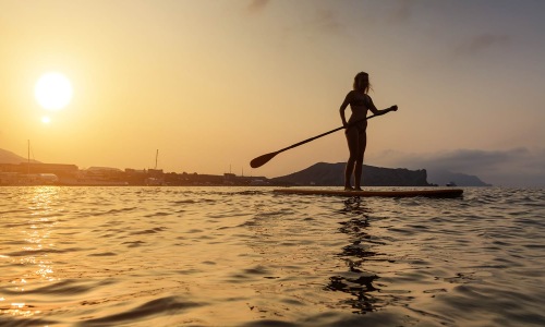 a girl paddle boarding