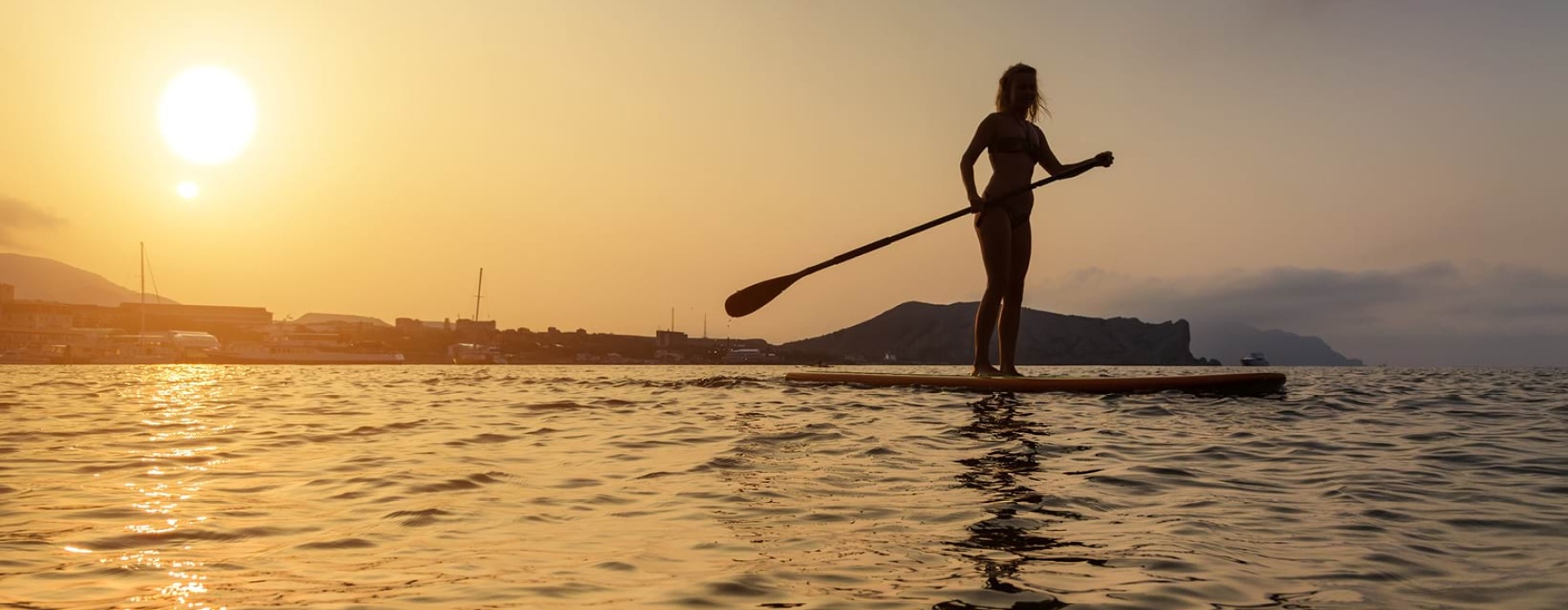 a girl paddle boarding