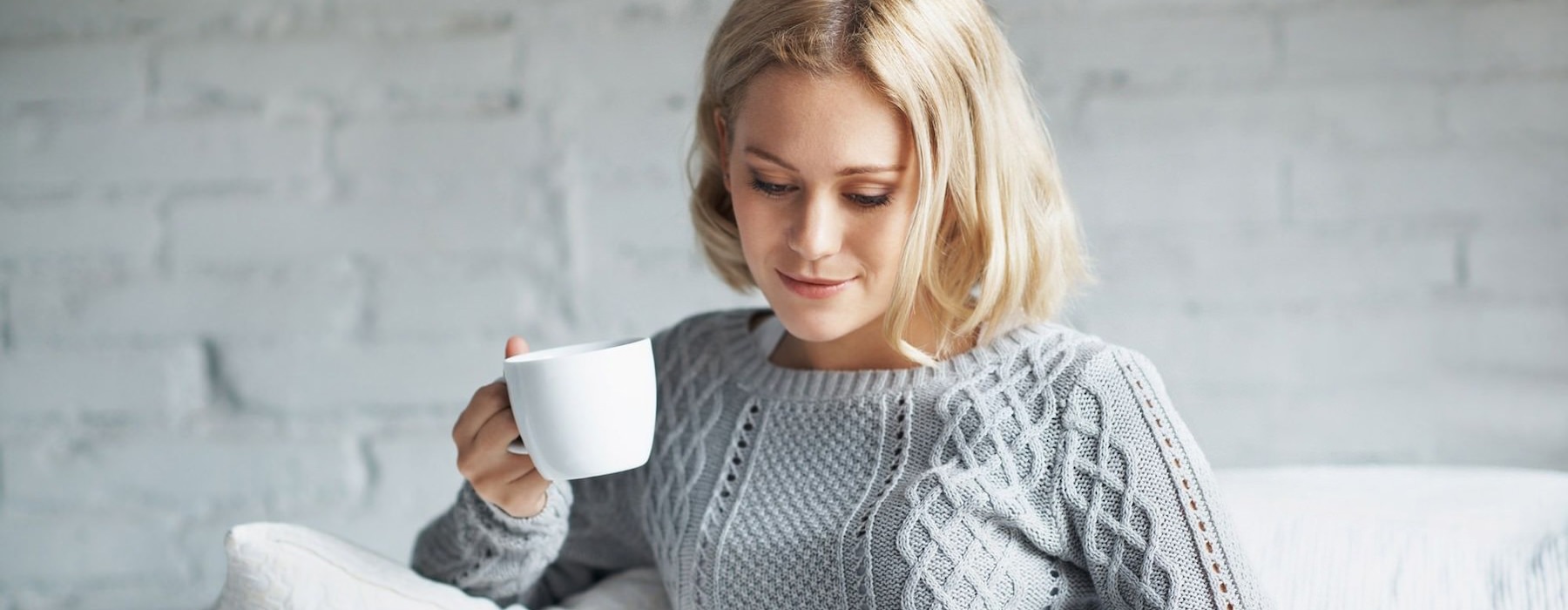 a person holding a cup of coffee