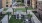 a courtyard with a fence and trees
