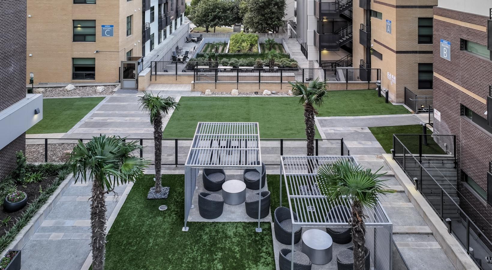 Find your perfect fit at Berkshire Riverview a courtyard with a fence and trees